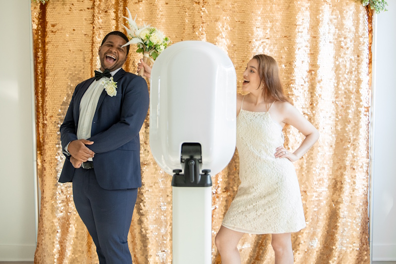 bride and groom posing in photobooth bride and groom posing in photobooth