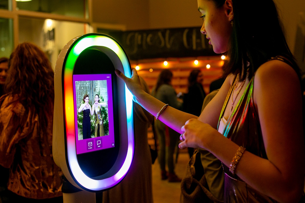 girl taking picture in photo booth girl taking picture in photo booth
