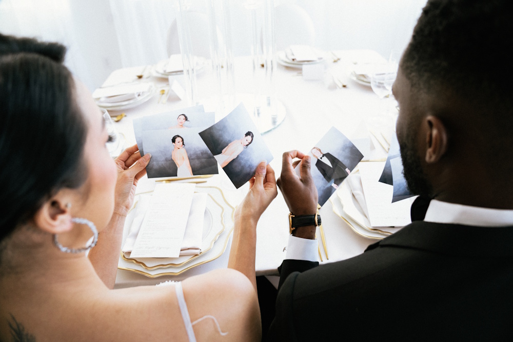 married couple looking at photobooth images